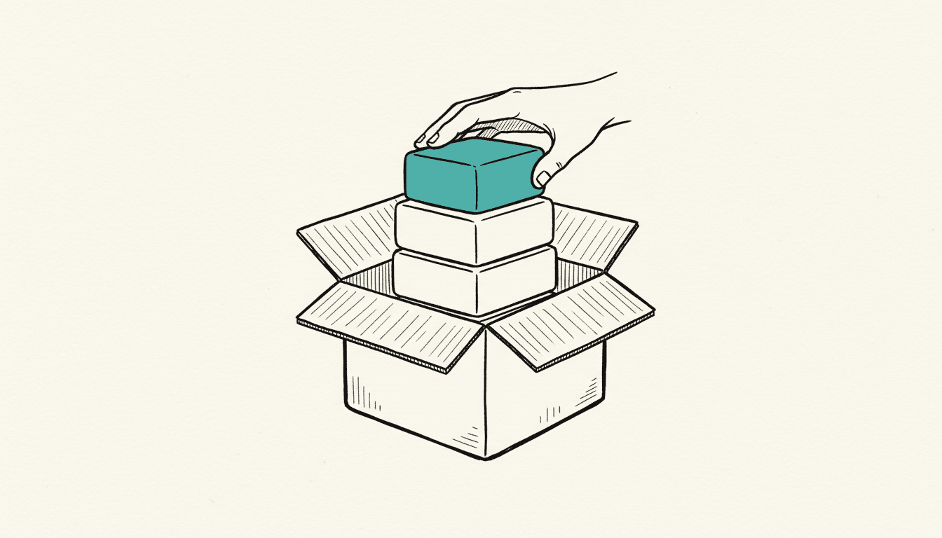 Hand-drawn sketch: an open box holding four stacked blocks, the smallest block on top filled in teal, a hand resting on the edge of the box.